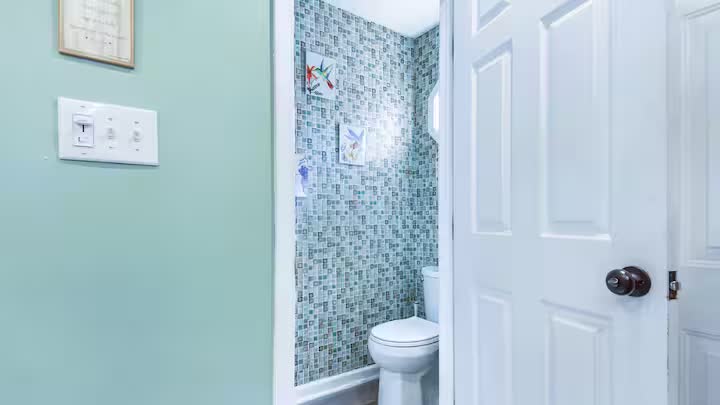 Half bath with sea-glass mosaic tile accent wall