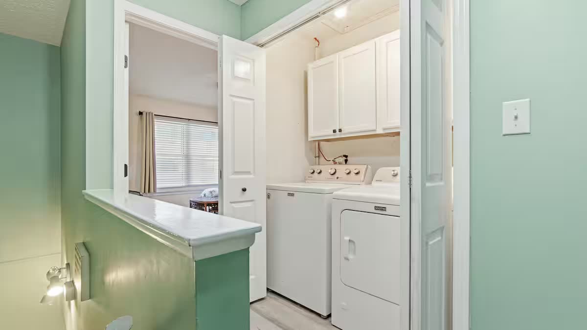 In-unit laundry closet with full-size washer and dryer