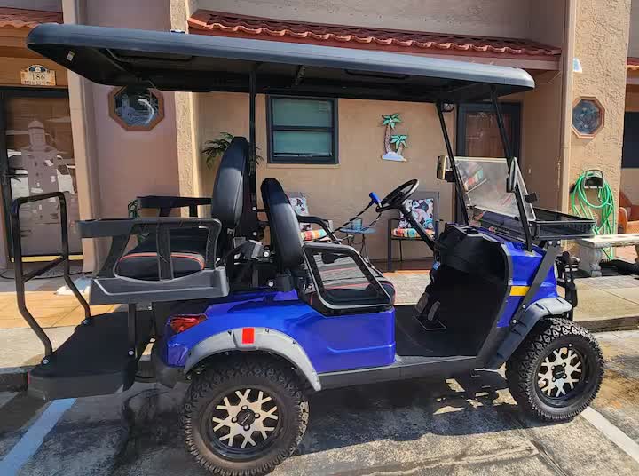 Blue 4-seater electric golf cart parked at the townhome